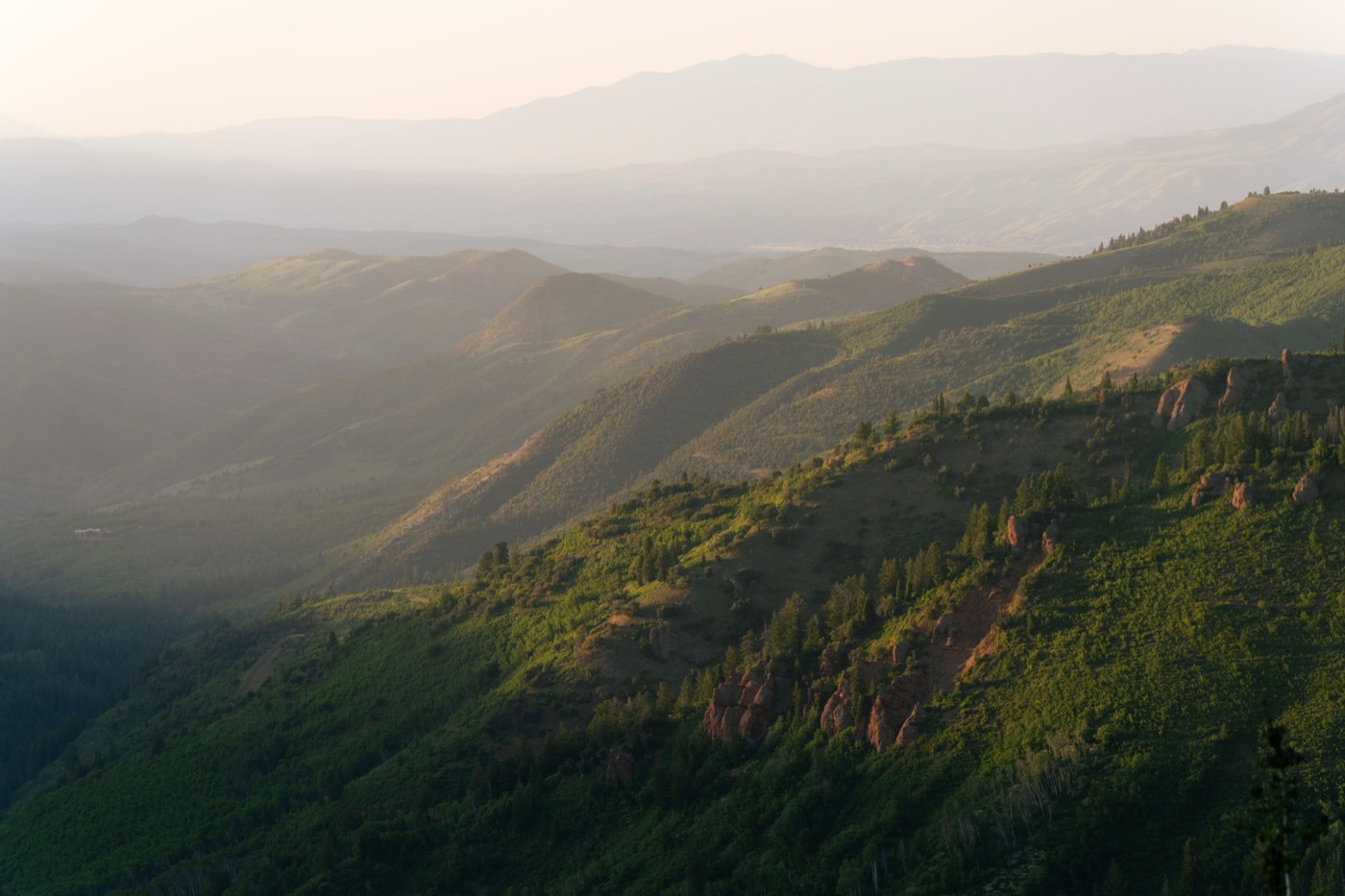 Green Utah mountain landscape at golden hour, representing the Beehive State Dragon Fury protects